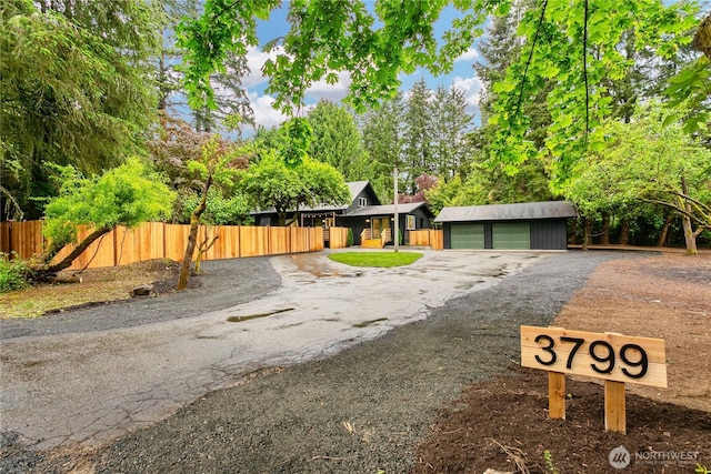view of front facade featuring fence and a garage