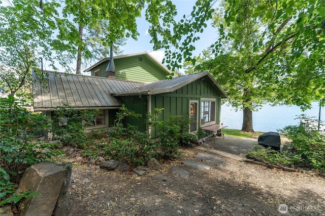 11194 S Lakeshore Rd, Chelan, WA 98816 - view of front of property with board and batten siding, a water view, and metal roof