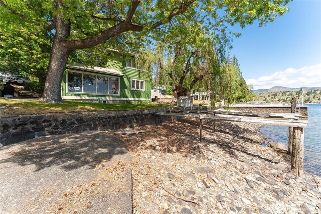 11194 S Lakeshore Rd, Chelan, WA 98816 - view of yard featuring a water and mountain view and a sunroom