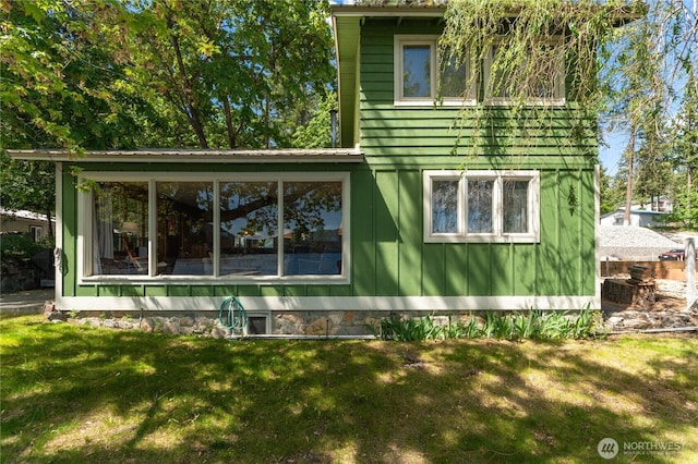 11194 S Lakeshore Rd, Chelan, WA 98816 - view of side of property with a yard, a sunroom, and board and batten siding