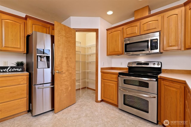 520 W Summer Breeze Ln, Sequim, WA 98382 - kitchen with appliances with stainless steel finishes, light countertops, recessed lighting, and brown cabinetry