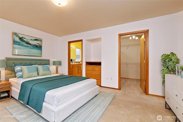520 W Summer Breeze Ln, Sequim, WA 98382 - bedroom featuring baseboards, light carpet, a walk in closet, a closet, and ensuite bathroom