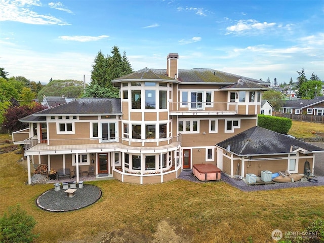 706 W 4th St, Port Angeles, WA 98363 - rear view of house featuring a patio, a lawn, a chimney, and a hot tub