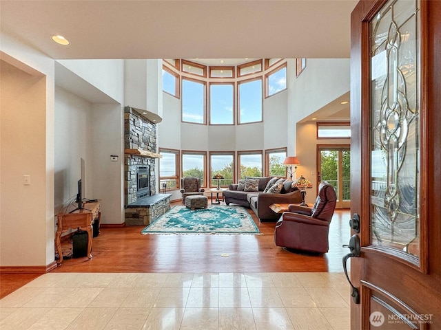 706 W 4th St, Port Angeles, WA 98363 - living room with a fireplace, baseboards, a towering ceiling, recessed lighting, and tile patterned floors