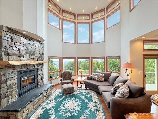 706 W 4th St, Port Angeles, WA 98363 - living area with a towering ceiling, wood finished floors, and a fireplace