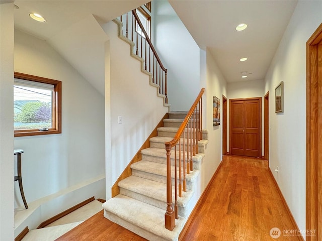 706 W 4th St, Port Angeles, WA 98363 - staircase featuring recessed lighting, wood finished floors, baseboards, and lofted ceiling
