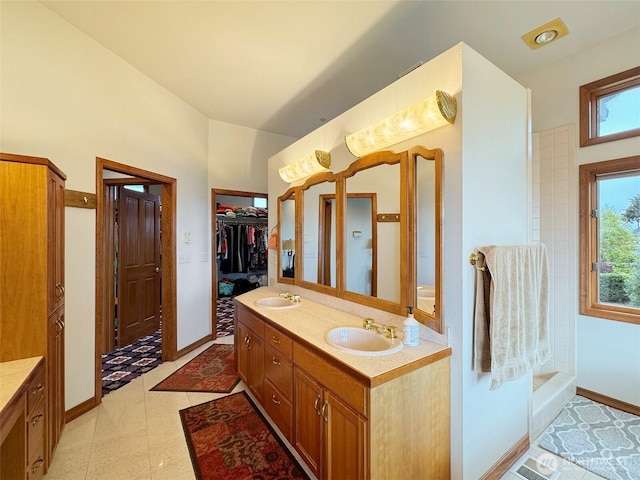 706 W 4th St, Port Angeles, WA 98363 - bathroom featuring baseboards, double vanity, and a spacious closet