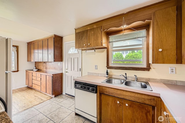 1204 S 229th St, Des Moines, WA 98198 - kitchen with white appliances, a sink, brown cabinetry, and healthy amount of natural light