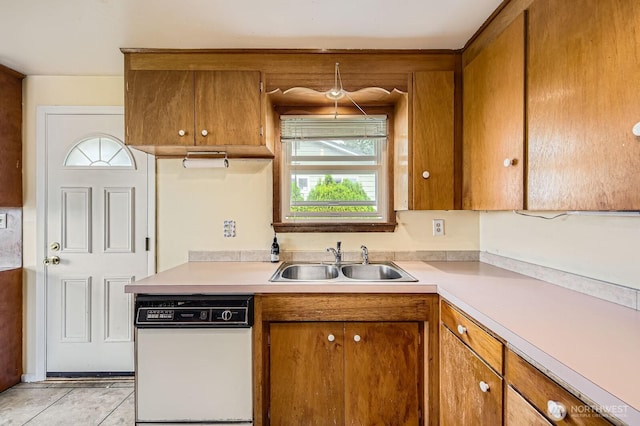 1204 S 229th St, Des Moines, WA 98198 - kitchen featuring white dishwasher, a sink, light countertops, and brown cabinetry