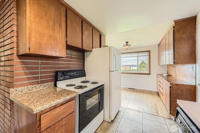 1204 S 229th St, Des Moines, WA 98198 - kitchen with range with electric cooktop, tasteful backsplash, light countertops, dishwasher, and light tile patterned flooring