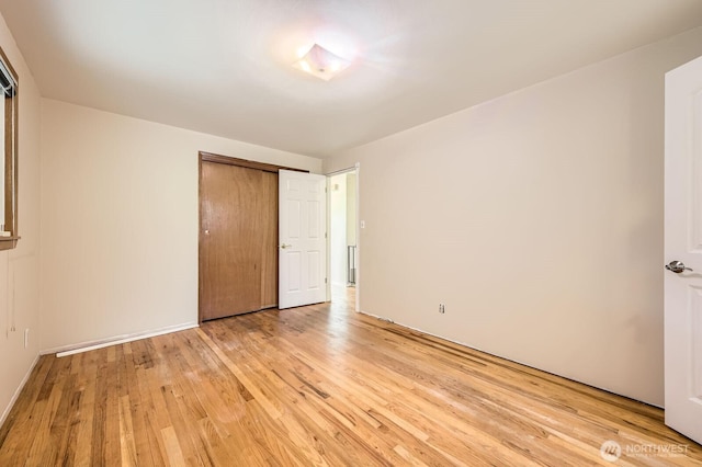 1204 S 229th St, Des Moines, WA 98198 - unfurnished bedroom featuring light wood finished floors and a closet
