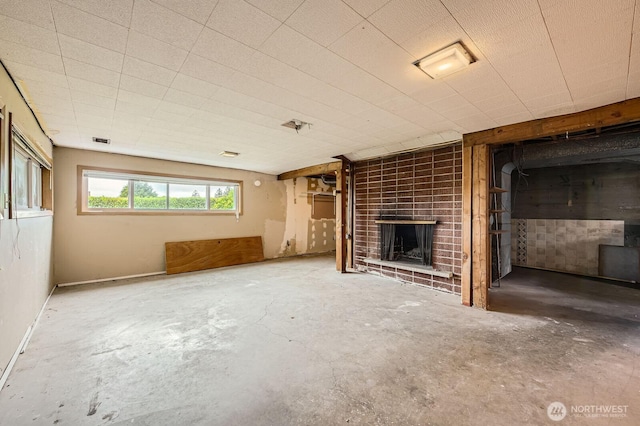 1204 S 229th St, Des Moines, WA 98198 - unfurnished living room with concrete flooring and a brick fireplace