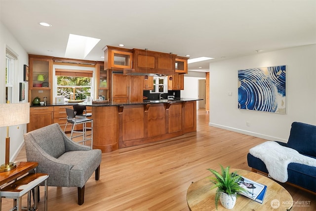 12515 2nd Ave NW, Seattle, WA 98177 - living area featuring a skylight, recessed lighting, light wood finished floors, and baseboards