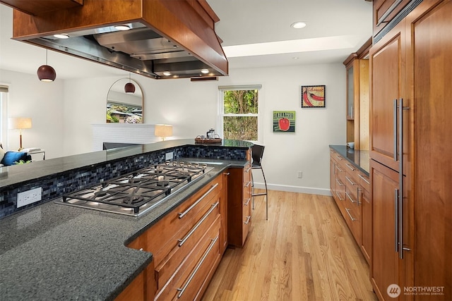 12515 2nd Ave NW, Seattle, WA 98177 - kitchen featuring stainless steel gas cooktop, brown cabinets, light wood-style floors, island range hood, and recessed lighting