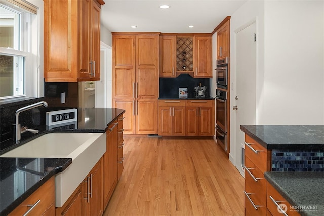 12515 2nd Ave NW, Seattle, WA 98177 - kitchen featuring brown cabinetry, light wood-style floors, recessed lighting, tasteful backsplash, and a warming drawer