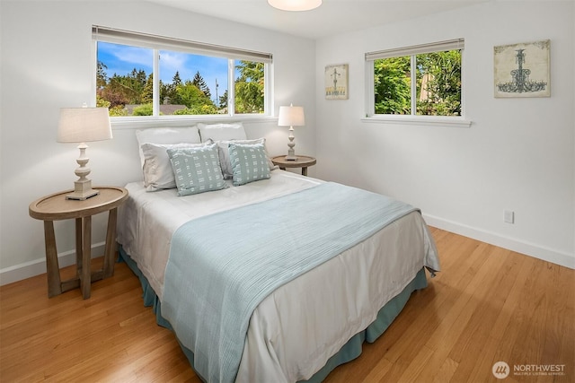 12515 2nd Ave NW, Seattle, WA 98177 - bedroom with multiple windows, baseboards, and wood finished floors