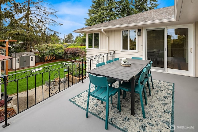 12515 2nd Ave NW, Seattle, WA 98177 - view of patio featuring a storage unit, an outdoor structure, and outdoor dining space