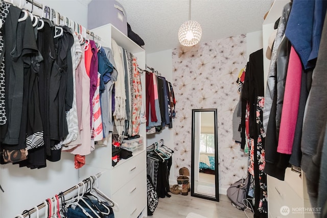 3160 SE Pierson St, Port Orchard, WA 98366 - walk in closet featuring wood finished floors and a chandelier