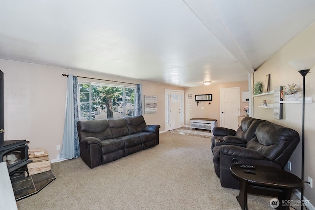 3160 SE Pierson St, Port Orchard, WA 98366 - carpeted living room featuring a wood stove and baseboards
