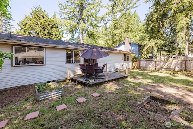3160 SE Pierson St, Port Orchard, WA 98366 - back of property with a deck, a vegetable garden, and outdoor dining area