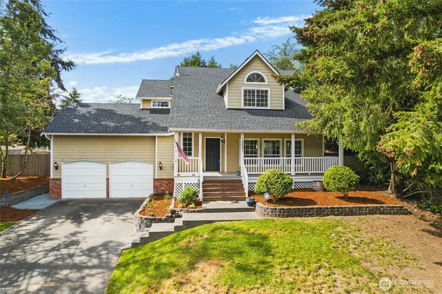 10901 194th Street Ct E, Graham, WA 98338 - view of front facade with asphalt driveway, covered porch, a shingled roof, an attached garage, and a front yard