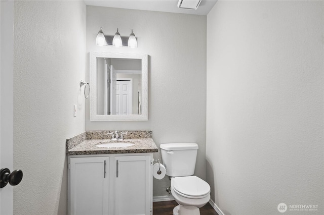 10901 194th Street Ct E, Graham, WA 98338 - bathroom with vanity, toilet, baseboards, and wood finished floors