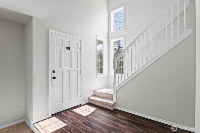 10901 194th Street Ct E, Graham, WA 98338 - foyer with stairs, baseboards, a towering ceiling, and dark wood finished floors