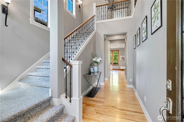 6611 Waterton Cir, Mukilteo, WA 98275 - entrance foyer featuring wood finished floors, stairway, a high ceiling, and baseboards