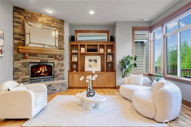 6611 Waterton Cir, Mukilteo, WA 98275 - living area with light wood finished floors, a stone fireplace, and recessed lighting