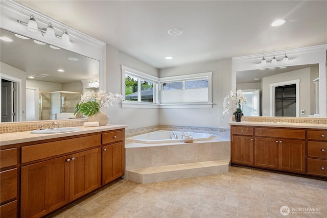 6611 Waterton Cir, Mukilteo, WA 98275 - full bathroom featuring a stall shower, a garden tub, two vanities, and recessed lighting