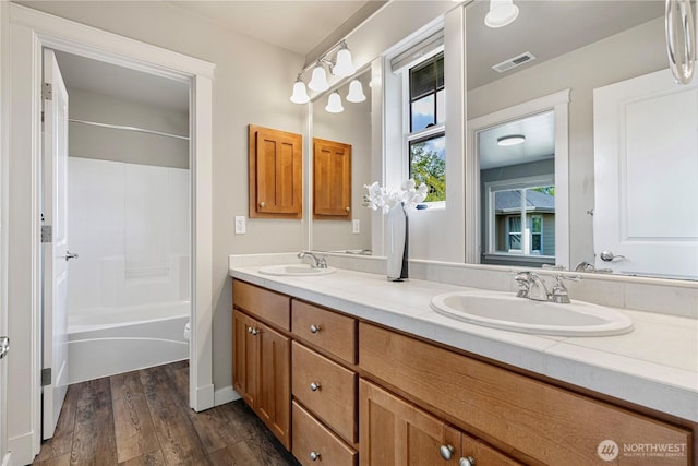 6611 Waterton Cir, Mukilteo, WA 98275 - bathroom featuring wood finished floors, double vanity, and shower / washtub combination