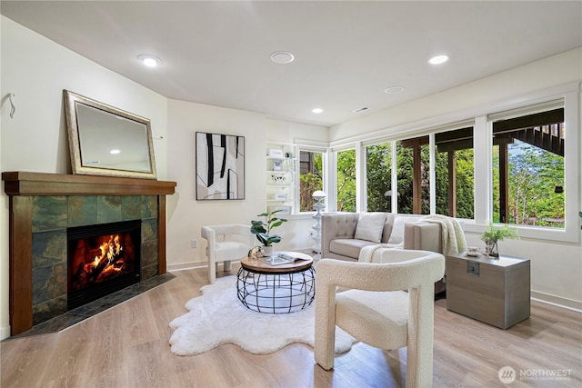 6611 Waterton Cir, Mukilteo, WA 98275 - living room with a tile fireplace, light wood-style flooring, baseboards, and recessed lighting