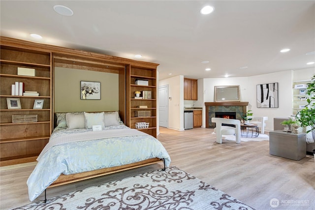 6611 Waterton Cir, Mukilteo, WA 98275 - bedroom with light wood finished floors, a high end fireplace, recessed lighting, and baseboards