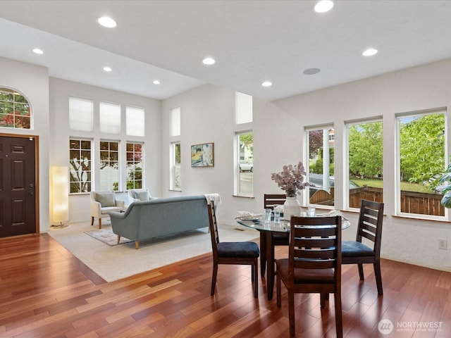 dining space with wood finished floors, healthy amount of natural light, and recessed lighting