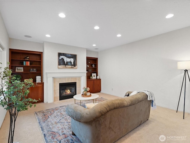 living area with light colored carpet, recessed lighting, a fireplace, and built in features