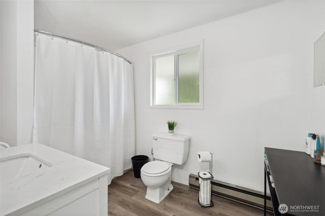6515 Lawrence Rd, Everson, WA 98247 - full bath featuring wood finished floors, toilet, a baseboard radiator, and vanity
