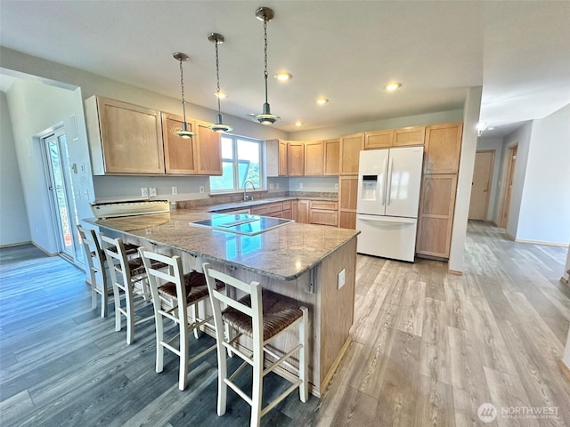 12 Diamond Dr, Pacific Beach, WA 98571 - kitchen featuring white refrigerator with ice dispenser, light brown cabinets, a peninsula, light wood-style floors, and black electric cooktop