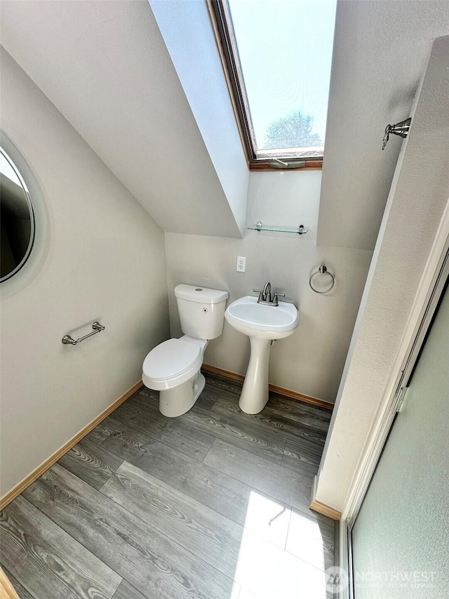 12 Diamond Dr, Pacific Beach, WA 98571 - bathroom with wood finished floors, a skylight, and vaulted ceiling