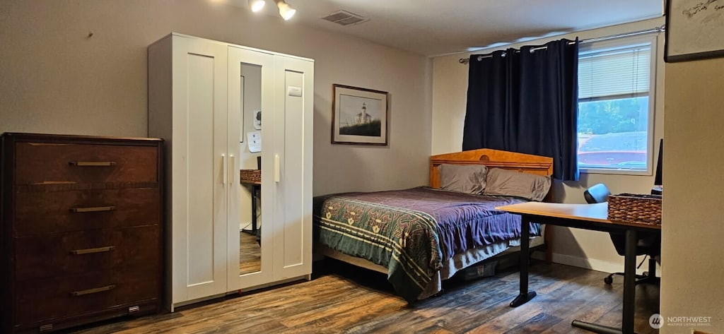 bedroom with dark wood-style floors