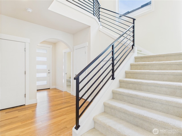 14419 45th Ln S, Tukwila, WA 98168 - stairway with arched walkways, wood finished floors, and baseboards