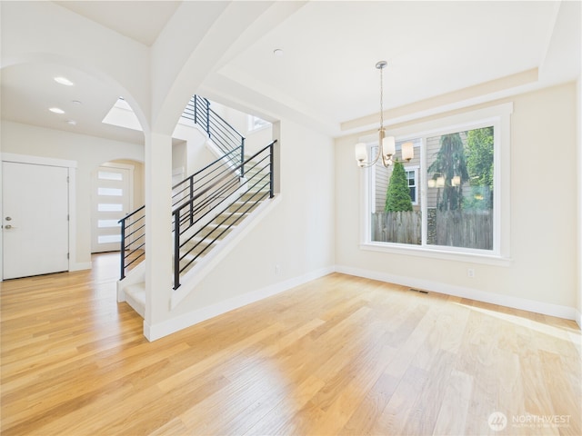 14419 45th Ln S, Tukwila, WA 98168 - spare room with wood finished floors, stairway, a chandelier, and a tray ceiling