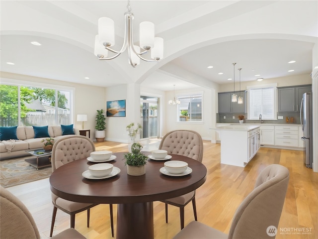 14419 45th Ln S, Tukwila, WA 98168 - dining space featuring a chandelier, arched walkways, healthy amount of natural light, recessed lighting, and light wood finished floors