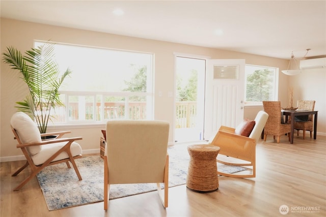 340 N Terrace Rd, Hoodsport, WA 98548 - living area with wood finished floors, a wall mounted air conditioner, baseboards, and recessed lighting