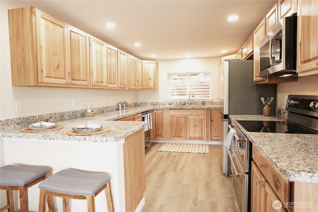 340 N Terrace Rd, Hoodsport, WA 98548 - kitchen featuring appliances with stainless steel finishes, light brown cabinets, a sink, a peninsula, and recessed lighting