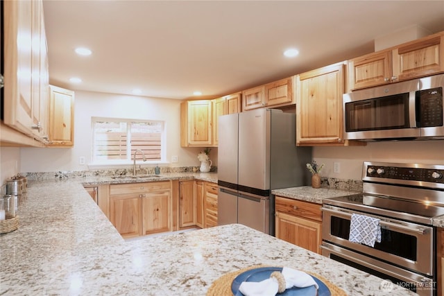 340 N Terrace Rd, Hoodsport, WA 98548 - kitchen with stainless steel appliances, a sink, light brown cabinetry, recessed lighting, and light stone countertops