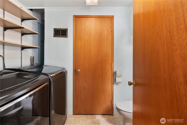 washroom with washing machine and dryer