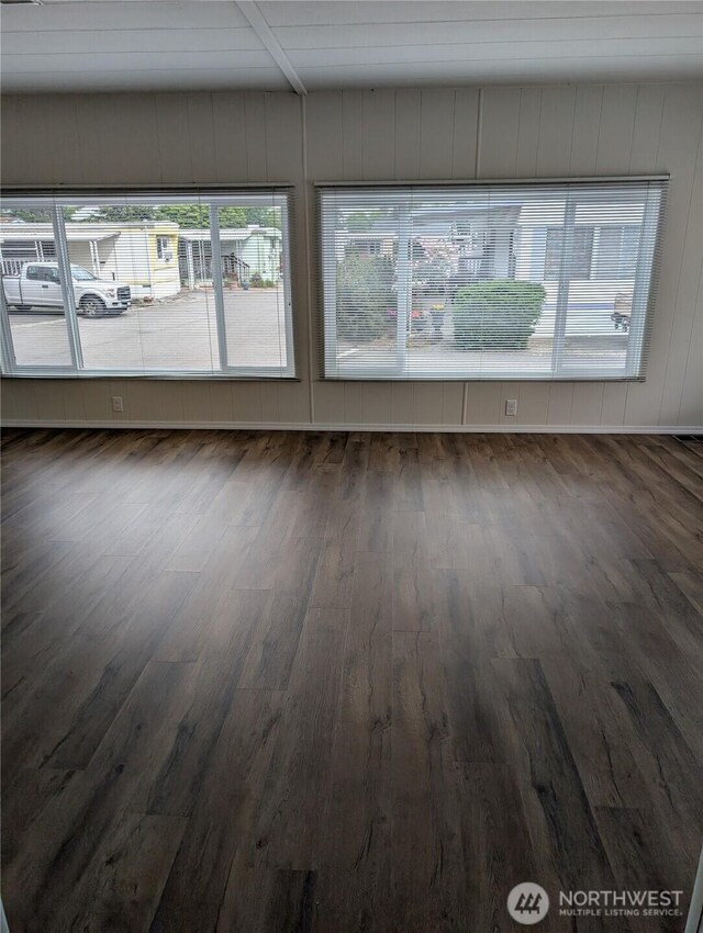 2302 R St SE Unit 128, Auburn, WA 98002 - spare room with wood finished floors and beamed ceiling