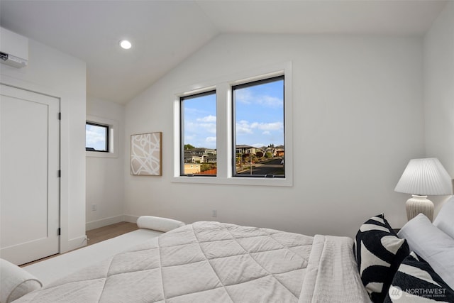 bedroom with a wall mounted air conditioner, vaulted ceiling, baseboards, recessed lighting, and wood finished floors
