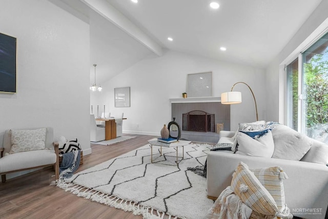 living area with wood finished floors, a fireplace, baseboards, recessed lighting, and a chandelier