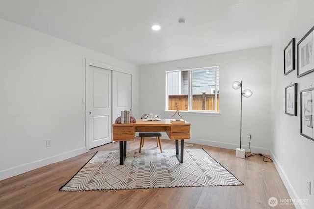 office space with light wood-style floors, baseboards, and recessed lighting